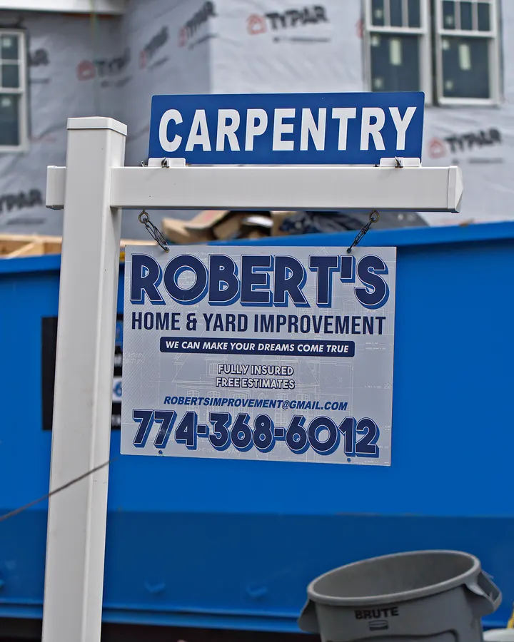 Robert's Home and Yard Improvement sign on an active job site